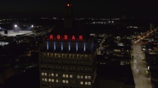 DX0002_210_055 - 5.7K aerial stock footage of approaching the top of Kodak Tower at night, Rochester, New York