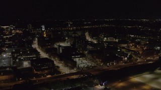 DX0002_210_058 - 5.7K aerial stock footage fly away from and by office buildings and the Inner Loop at night, Downtown Rochester, New York