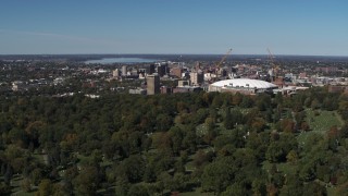 DX0002_211_003 - 5.7K aerial stock footage of flyby cemetery, Carrier Dome and Downtown Syracuse, New York