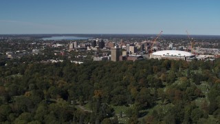 DX0002_211_004 - 5.7K aerial stock footage of Carrier Dome and Downtown Syracuse, New York seen from cemetery