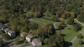 DX0002_211_006 - 5.7K aerial stock footage fly away from graves at Morningside Cemetery near homes  in Syracuse, New York
