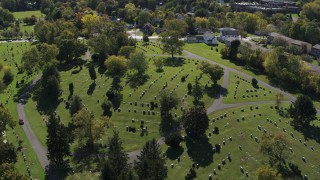 DX0002_211_010 - 5.7K aerial stock footage of orbiting gravestones at Morningside Cemetery in Syracuse, New York