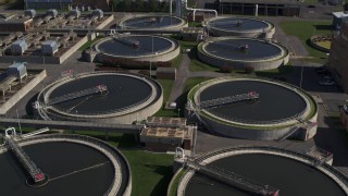 DX0002_211_017 - 5.7K aerial stock footage of circling tanks at a sewage treatment plant in Syracuse, New York