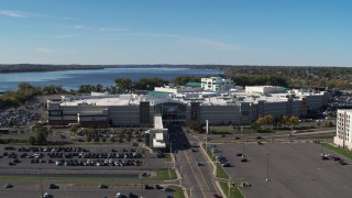 DX0002_212_018 - 5.7K aerial stock footage of the Destiny USA shopping mall with lake in the background, Syracuse, New York