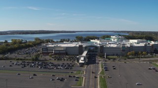DX0002_212_021 - 5.7K aerial stock footage of flying away from the Destiny USA shopping mall with lake in the background, Syracuse, New York