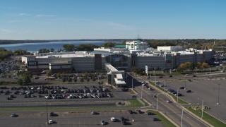 DX0002_212_027 - 5.7K aerial stock footage descend and fly away from parking lots and the Destiny USA shopping mall, Syracuse, New York