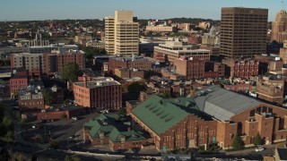 DX0002_213_035 - 5.7K aerial stock footage orbit Museum of Science & Technology, office buildings in background, Downtown Syracuse, New York
