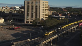 DX0002_214_001 - 5.7K aerial stock footage of a train running near the 500 Building, Downtown Syracuse, New York
