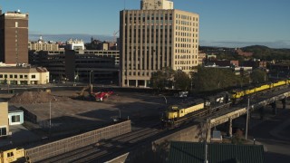 DX0002_214_002 - 5.7K aerial stock footage of a train near the 500 Building, Downtown Syracuse, New York