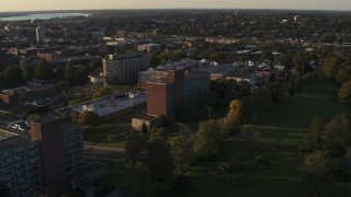DX0002_214_011 - 5.7K aerial stock footage of approaching Booth Hall at Syracuse University at sunset, New York