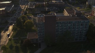 DX0002_214_012 - 5.7K aerial stock footage of orbiting Booth Hall at Syracuse University at sunset, New York