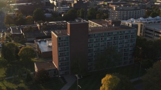 DX0002_214_013 - 5.7K aerial stock footage of circling Booth Hall at Syracuse University at sunset, New York