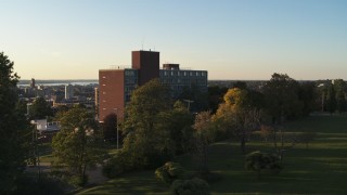 DX0002_214_014 - 5.7K aerial stock footage focus on Booth Hall while descending at Syracuse University at sunset, New York