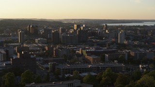 DX0002_214_017 - 5.7K aerial stock footage of passing by downtown seen from Syracuse University at sunset, New York