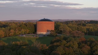 DX0002_214_031 - 5.7K aerial stock footage of the Stewart Stand Pipe at Thornden Park while descending, Syracuse at sunset, New York