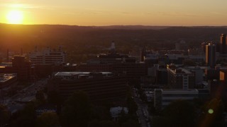 DX0002_214_032 - 5.7K aerial stock footage of orbiting Crouse Hospital in Downtown Syracuse at sunset, New York