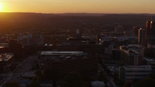DX0002_214_033 - 5.7K aerial stock footage orbit Crouse Hospital in Downtown Syracuse at sunset, New York