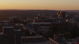 DX0002_214_034 - 5.7K aerial stock footage a wide orbit of Crouse Hospital in Downtown Syracuse at sunset, New York