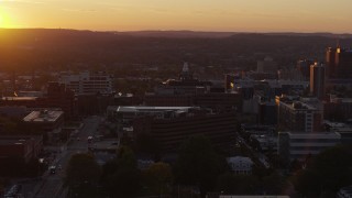 DX0002_214_035 - 5.7K aerial stock footage of circling Crouse Hospital in Downtown Syracuse at sunset, New York
