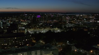 DX0002_215_006 - 5.7K aerial stock footage of city buildings in Downtown Syracuse at twilight while flying by university, New York