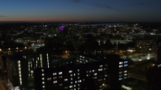 DX0002_215_007 - 5.7K aerial stock footage of city buildings in Downtown Syracuse at twilight while ascending over university, New York