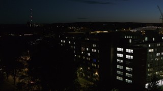 DX0002_215_010 - 5.7K aerial stock footage of circling university dormitory at twilight, Syracuse, New York