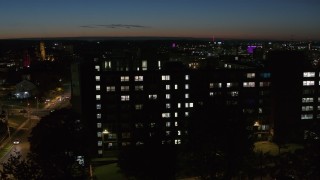 DX0002_215_011 - 5.7K aerial stock footage of an orbit of Dellplain Hall university dormitory at twilight, Syracuse, New York