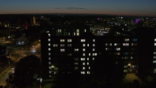 DX0002_215_012 - 5.7K aerial stock footage of the Dellplain Hall university dormitory at twilight, Syracuse, New York
