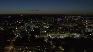 DX0002_215_017 - 5.7K aerial stock footage flying by Syracuse University at twilight while focused on Downtown Syracuse, New York