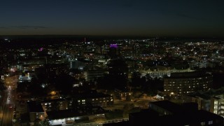 DX0002_215_021 - 5.7K aerial stock footage descend by Syracuse University at twilight while focused on Downtown Syracuse, New York