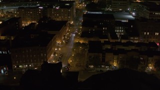 DX0002_215_023 - 5.7K aerial stock footage of orbiting Franklin Street at night, Downtown Syracuse, New York