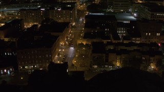 DX0002_215_024 - 5.7K aerial stock footage of slowly orbiting Franklin Street at night, Downtown Syracuse, New York
