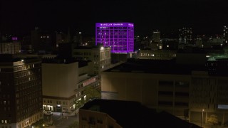 DX0002_215_027 - 5.7K aerial stock footage orbit Barclay Damon Tower at night, reveal apartment complex in Downtown Syracuse, New York