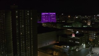 DX0002_215_029 - 5.7K aerial stock footage orbit Barclay Damon Tower and apartment complex at night, Downtown Syracuse, New York