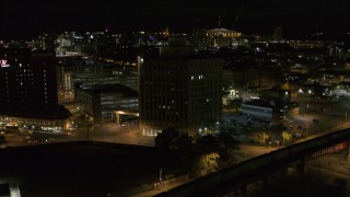 DX0002_215_030 - 5.7K aerial stock footage of orbiting a dark office building at night, Downtown Syracuse, New York
