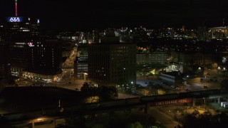 DX0002_215_031 - 5.7K aerial stock footage orbit a dark office building at night, Downtown Syracuse, New York