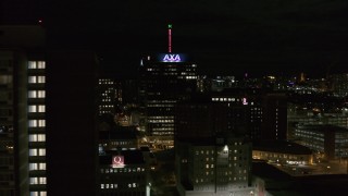 DX0002_215_034 - 5.7K aerial stock footage flyby apartment complex to reveal office tower and hotel at night, Downtown Syracuse, New York