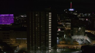 DX0002_215_037 - 5.7K aerial stock footage orbit an apartment complex at night, Downtown Syracuse, New York