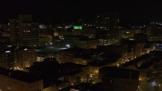 DX0002_215_038 - 5.7K aerial stock footage of One Lincoln Center and city buildings at night, Downtown Syracuse, New York