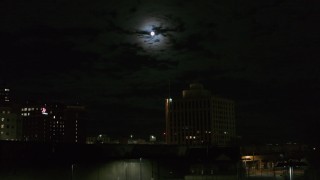 DX0002_215_041 - 5.7K aerial stock footage of the moon above the 500 Building at night, Downtown Syracuse, New York