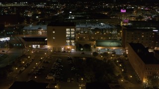 DX0002_215_047 - 5.7K aerial stock footage of flying toward an office building at night, Downtown Syracuse, New York