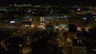 DX0002_215_048 - 5.7K aerial stock footage of flying away from an office building at night, Downtown Syracuse, New York