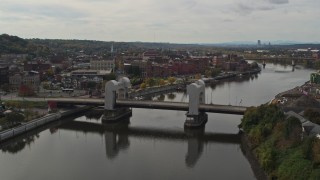 DX0002_216_011 - 5.7K aerial stock footage descend and fly away from the downtown area of Troy, New York, reveal a bridge
