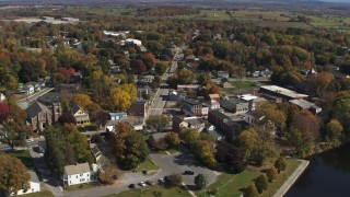 DX0002_216_019 - 5.7K aerial stock footage of a reverse view of a small town intersection in Fort Edward, New York