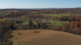 DX0002_216_030 - 5.7K aerial stock footage of orbiting the small town of Fort Ann, New York, seen from corn fields