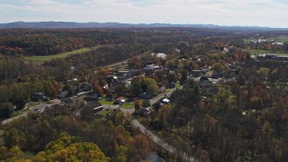 DX0002_216_036 - 5.7K aerial stock footage fly away from and orbit the small town of Fort Ann, New York
