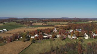 DX0002_217_003 - 5.7K aerial stock footage approach a church in the small town of Orwell, Vermont, farm fields in background