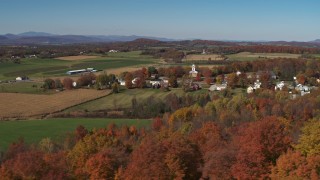 DX0002_217_005 - 5.7K aerial stock footage orbit farm fields and the small town of Orwell, Vermont