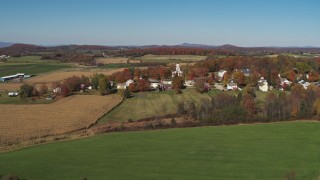 DX0002_217_006 - 5.7K aerial stock footage approach and orbit farm fields around the small town of Orwell, Vermont