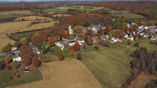 DX0002_217_007 - 5.7K aerial stock footage orbit the small town of Orwell, Vermont surrounded by farm fields